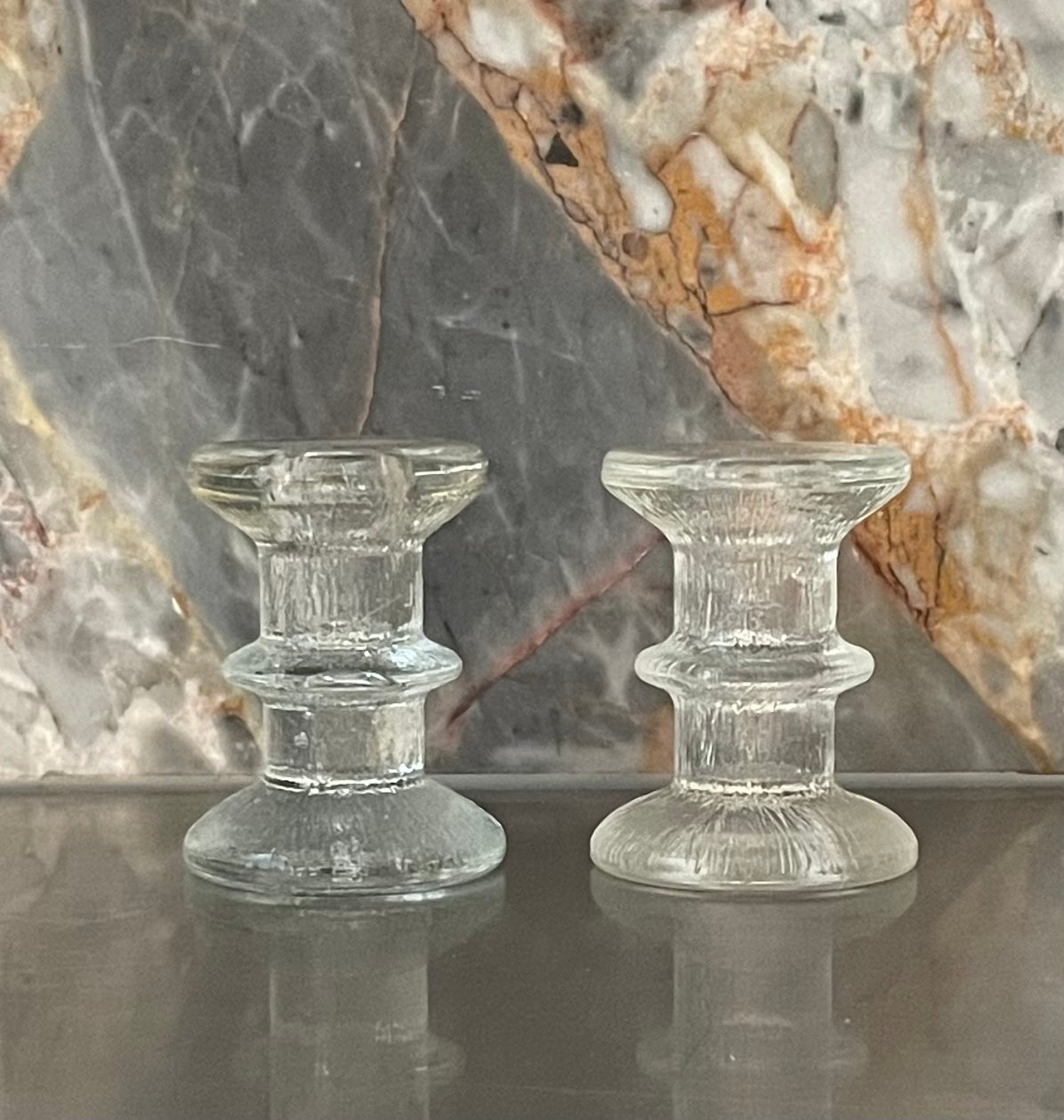 A pair of candlesticks in the style of Iittala