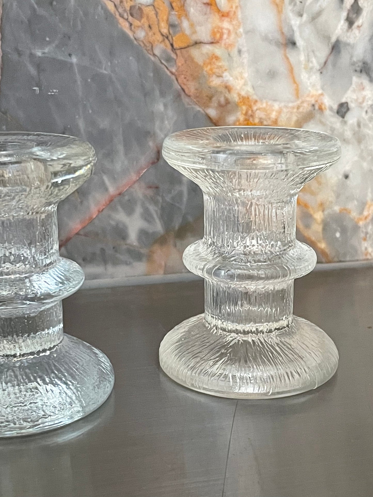 A pair of candlesticks in the style of Iittala