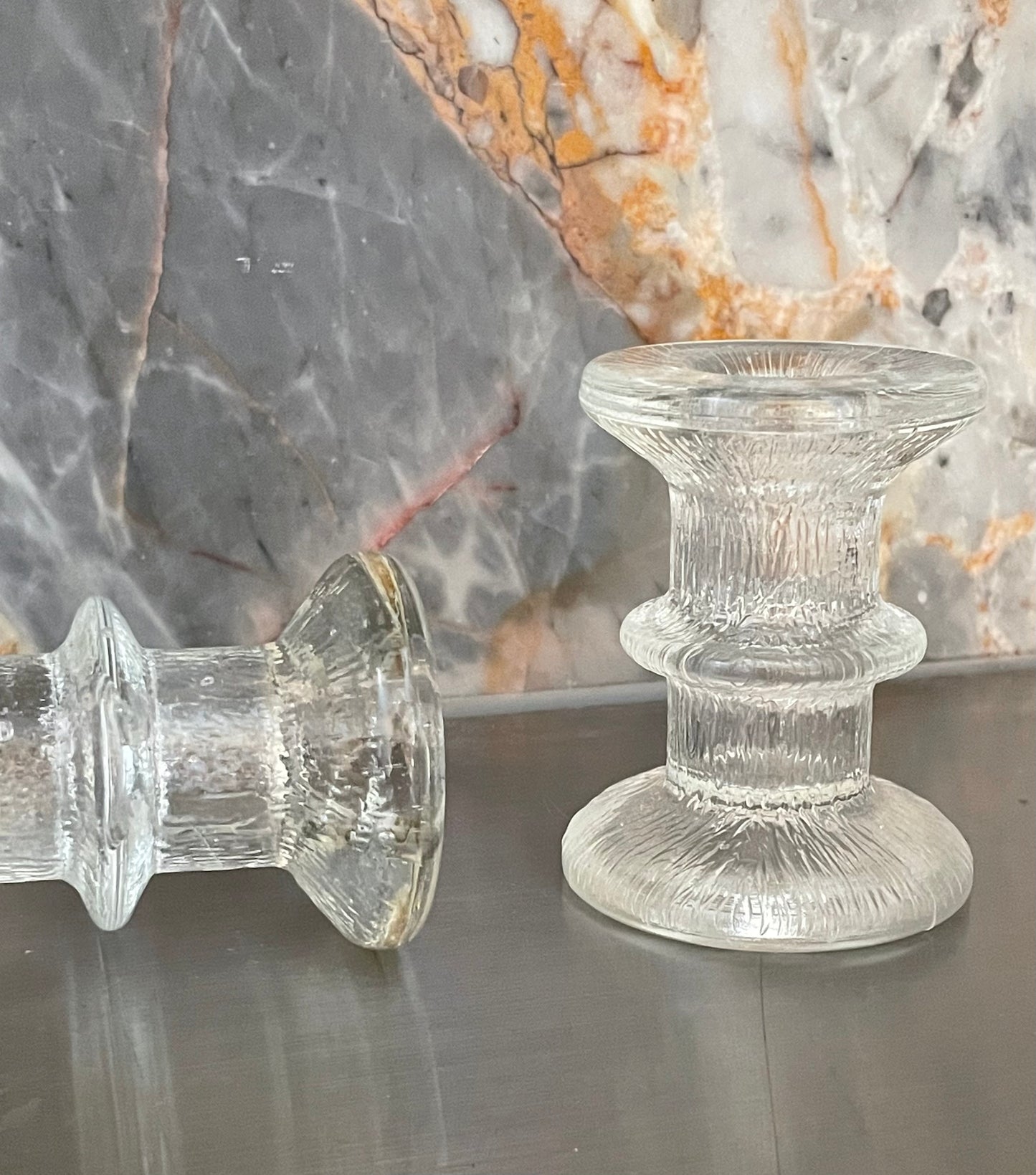 A pair of candlesticks in the style of Iittala